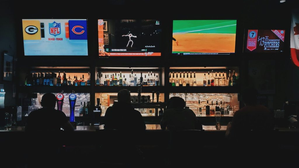 men watching flat screen monitors